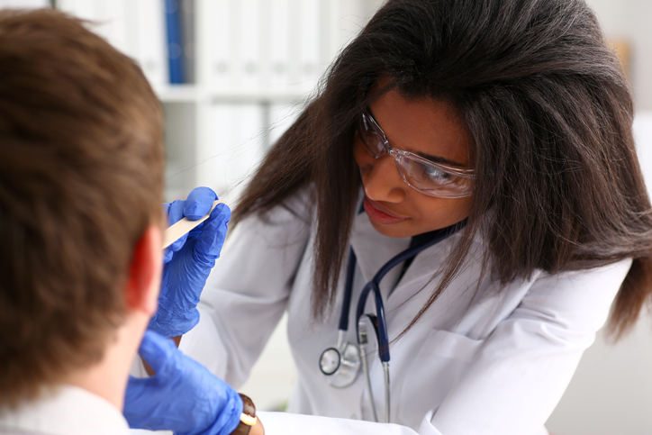 A doctor examining a patient during national health center week.