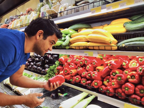 Guy buying veggies during Men's Health Month